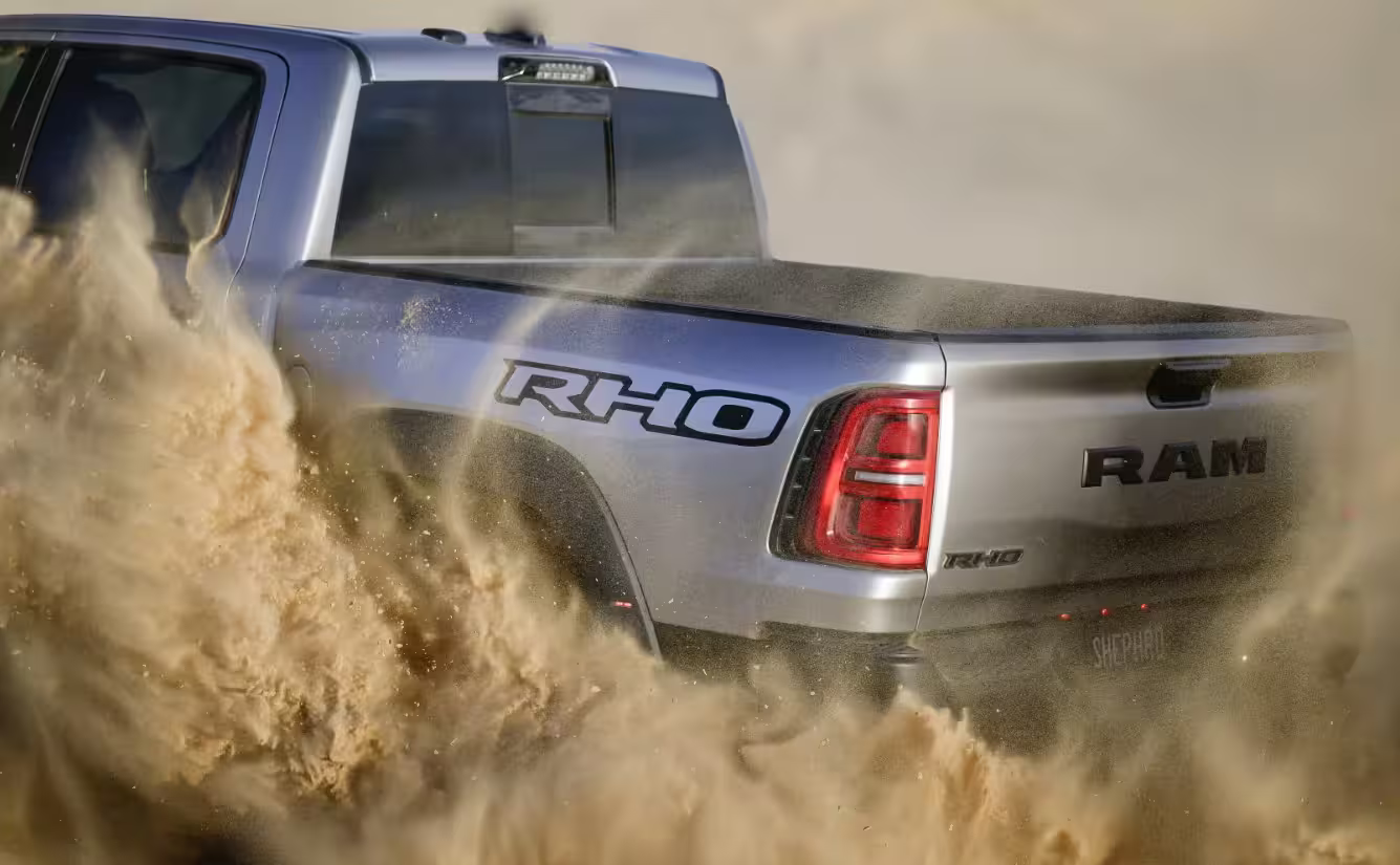 20225 RAM 1500 RHO driving through the desert, rear side view