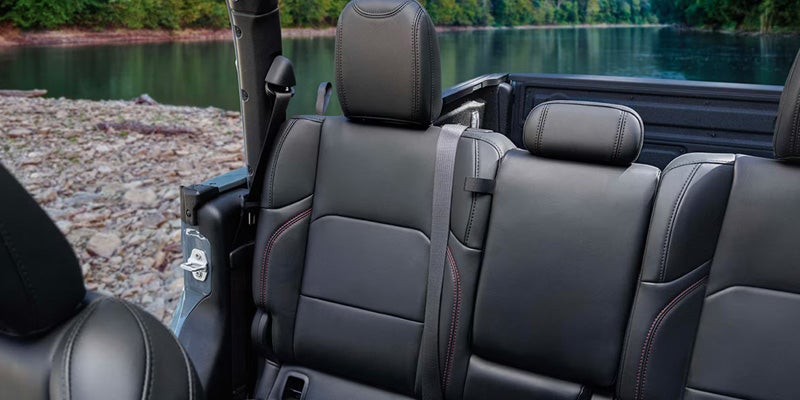 Jeep Gladiator interior with black leather rear seats and open-air cabin design.