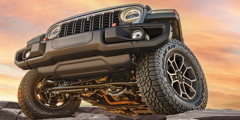 Jeep Gladiator front suspension and off-road tires showcasing rugged capability.