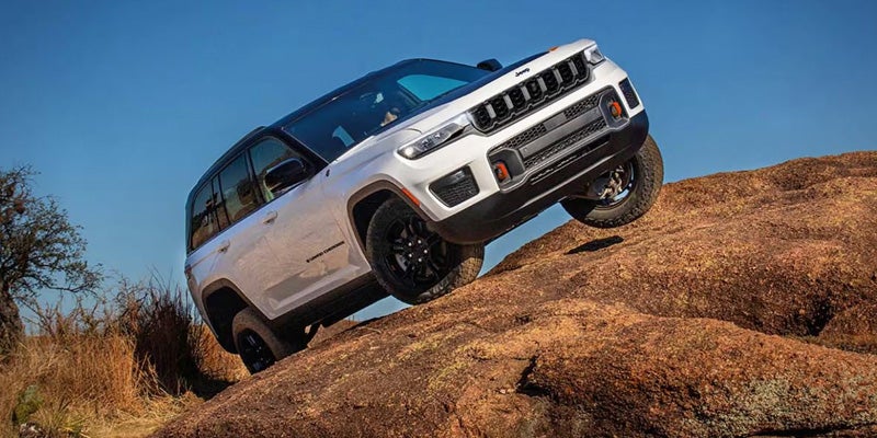 Jeep Grand Cherokee climbing a rocky hill showcasing off-road performance.