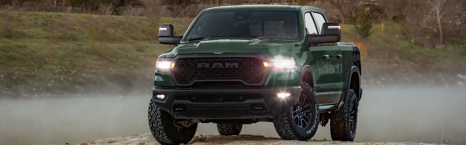2026 Ram 1500 pickup truck driving through rugged terrain