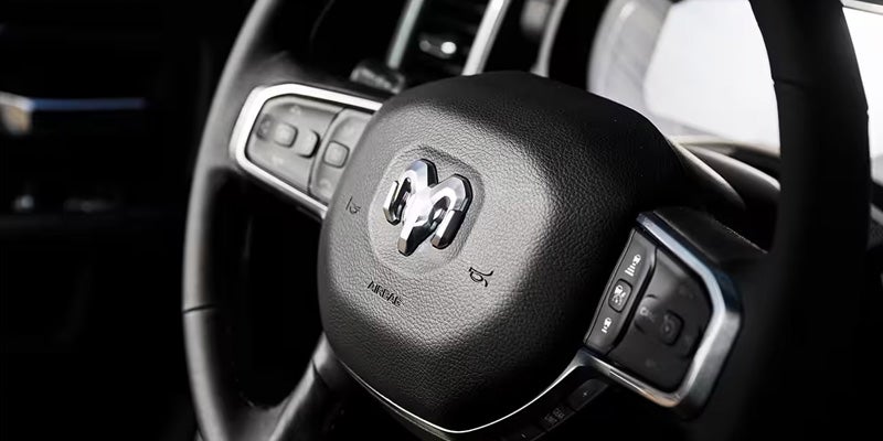 Ram 2500 interior steering wheel with mounted controls and dashboard details.