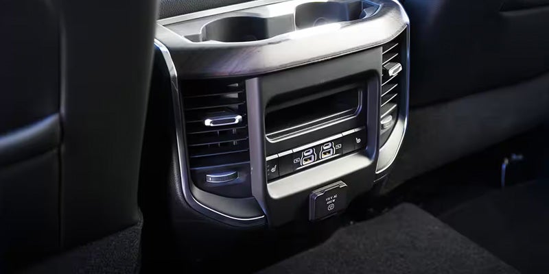 Ram 2500 rear cabin console with climate controls and storage features.