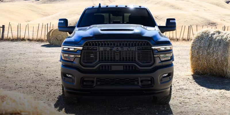 Blue Ram 2500 pickup truck parked on a rugged outdoor landscape.