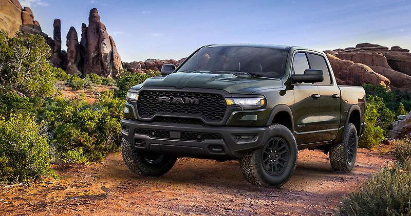 2026 RAM 1500 Rebel X ridind on dirt road showing off-road strength.
