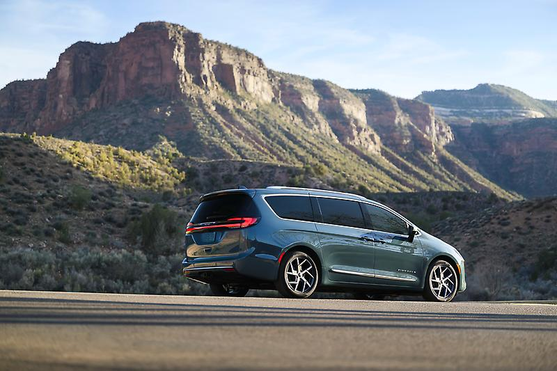 2027 Chrysler Pacifica driving near mountains.